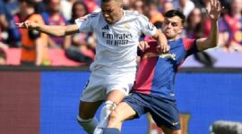 Mbappe pergi ke bola melawan Pedri dalam pertandingan Real kalah dari Barca 3-4 di babak ke-35 La Liga pada 11/5/2025. Foto: AFP